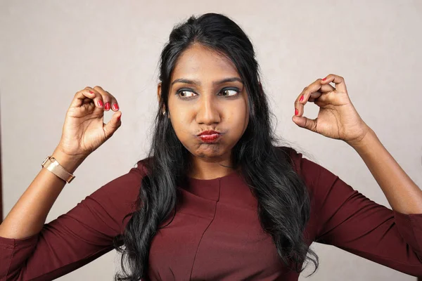 Asian Indian origin dark skin tone beautiful woman facial hand expression making faces hand signs funny