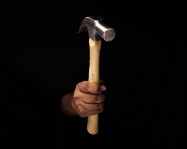 Asyalı, esmer, tek elli, siyah arka planda çekiç kullanan bir erkek parmak. 