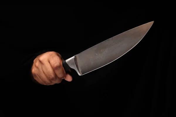 Asian male dark skinned single hand fist finger on black background holding stainless steel knife
