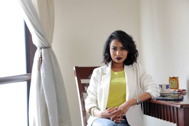 Asian female dark skinned Indian Bengali subcontinent at home office table chair busness work study look smile emotion confident  