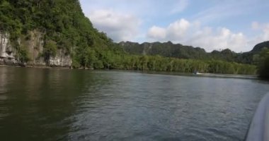 Camara shake hating wave riding gliding floating flying over sea water mangrove forest on speedboat 