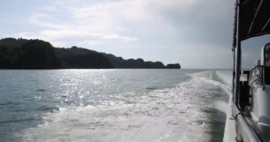 Camara shake hating wave riding gliding floating flying over sea water mangrove forest on speedboat 