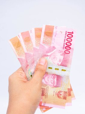 close up view of people man woman holding Money isolated on white background. Indonesian Rupiah.