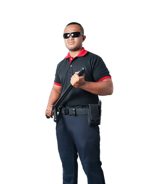黒の制服を着た警備員が45度の角度に立っており 強いスタンドとゴム製のバトンを持っている 白い背景に切り取られています セキュリティの概念 — ストック写真