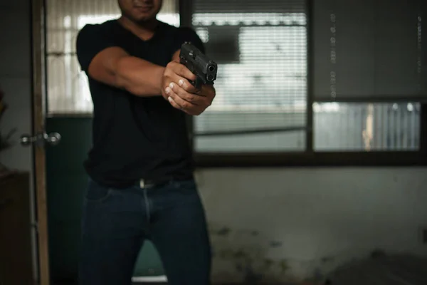 Man Holding Pistol Standing Room Black Pointing Aiming Gun Target — Stock Photo, Image