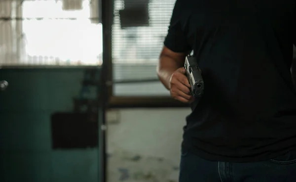 Man Holding Pistol Standing Room Black Pointing Aiming Gun Target — Stock Photo, Image