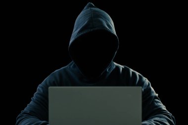 Big financial data theft concept. An anonymous hacker is hacking highly-protected financial data through computers.