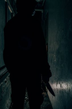 Behind the murderer, he held a blood-stained knife that killed his victim in a very terrifying and terrifying way.