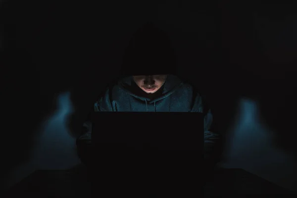 Hacker Wears Long Sleeved Shirt Hood Covering His Head Sitting — Stockfoto