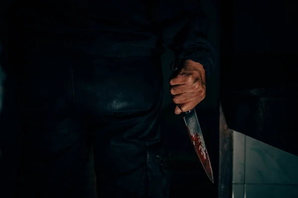 Behind the murderer, he held a blood-stained knife that killed his victim in a very terrifying and terrifying way.