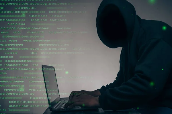 Hacker Wearing Black Hoodie Stealing Huge Financial Data Computers Binary 免版税图库照片