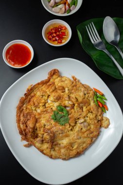 Minced pork omelette in white plate served with tomato sauce, fast food, high protein rental top view.