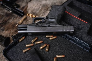 Disassembly and cleaning Maintaining a 9mm semi-automatic pistol on a wooden table.