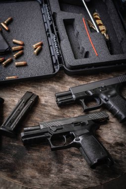 Disassembly and cleaning Maintaining a 9mm semi-automatic pistol on a wooden table.