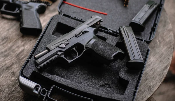 Disassembly and cleaning Maintaining a 9mm semi-automatic pistol on a wooden table.