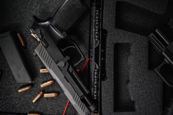 Disassembly and cleaning Maintaining a 9mm semi-automatic pistol on a wooden table.