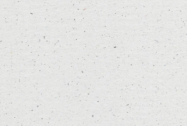 Close-up weergave van grijs papier gerecycleerde achtergrond met insluitsels van papierdeeltjes. Concept gerecycled papier. — Stockfoto