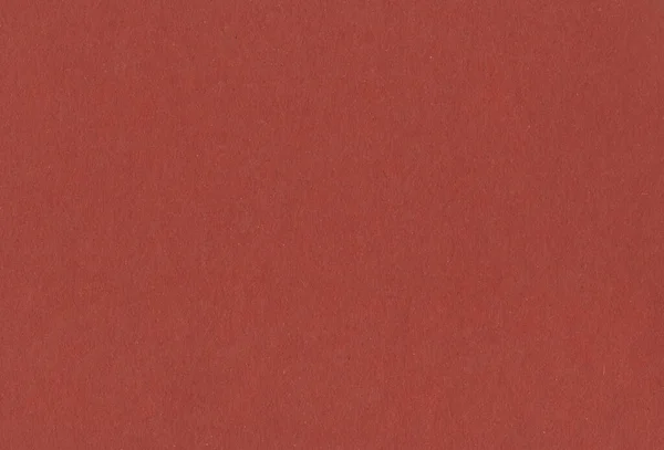 Warme rode kartonnen achtergrond met insluitsels van gerecycleerde papierdeeltjes. Concept gerecycled papier. — Stockfoto