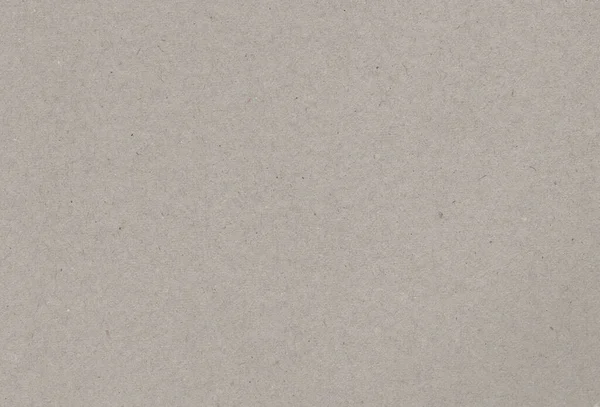 Bruinachtig grijs papieren kartonnen ondergrond met insluitsels van gerecycleerde papierdeeltjes. Concept gerecycled papier. — Stockfoto