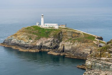 Holyhead, Anglesey, Gwynedd, Galler, İngiltere - 08 Haziran 2018 - Kayalıklara ve Güney Yığını Deniz fenerine doğru bakın