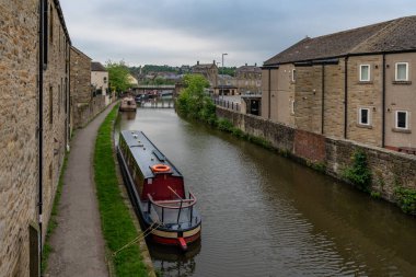 Skipton, Kuzey Yorkshire, İngiltere - Haziran 04, 2018: Leeds ve Liverpool Kanalı kıyısındaki evler ve dar botlar