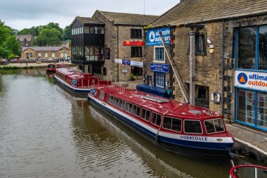 Skipton, Kuzey Yorkshire, İngiltere - Haziran 04, 2018: Leeds ve Liverpool Kanalı kıyısındaki evler ve dar botlar