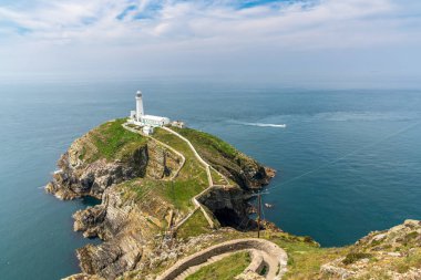 Holyhead, Anglesey, Gwynedd, Galler, İngiltere - 08 Haziran 2018 - Kayalıklara ve Güney Yığını Deniz fenerine doğru bakın