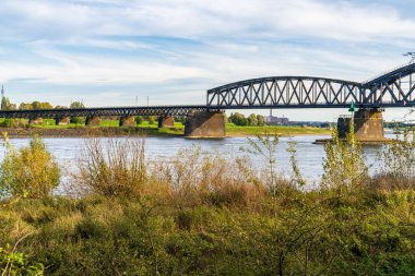 Duisburg, Kuzey Ren-Westfalia, Almanya - 26 Ekim 2019: Arka planda Beeckerwerther Köprüsü ve Haus-Knipp Demiryolu Köprüsü ile Duisburg-Baerl 'deki Ren Nehri manzarası