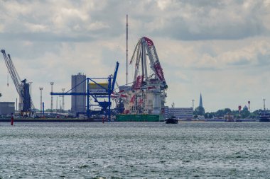 Rostock, Mecklenburg-Batı Pomerania, Almanya - 14 Haziran 2020: Liman yolcu gemisi ve arka planda hasar gören Liebherr ağır kaldırma vinci ile limana bakın