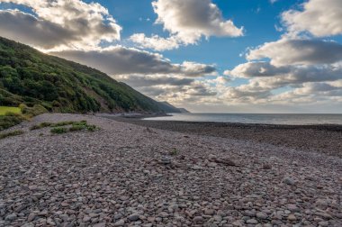 Porlock Weir, Somerset, İngiltere 'deki çakıl taşı plajından Bristol kanalına bakıyor.