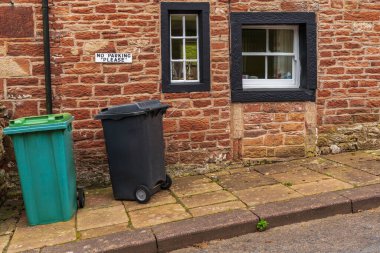 Bir evin önündeki çöp tenekelerinde 