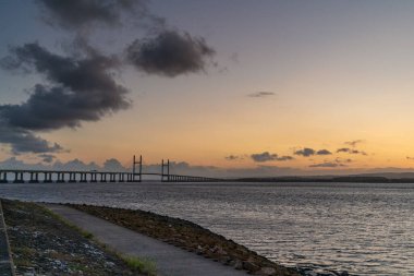 The Prince of Wales Köprüsü ve Severn Nehri 'nde akşam Redwick, Güney Gloucestershire, İngiltere' den görüldü.