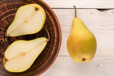 Kil tabakta iki organik armut ve ahşap bir masada bir armut, makro, üst manzara..