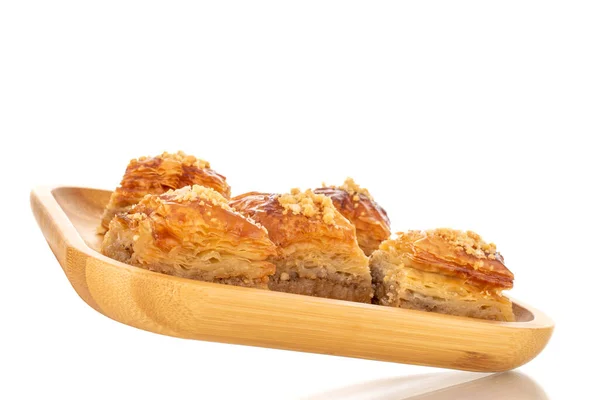 stock image Sweet baklava classic on a bamboo tray, macro, isolated on a white background.