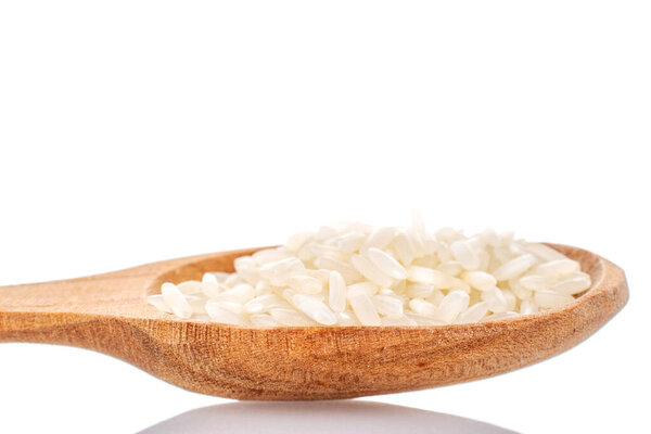 Uncooked organic rice with wooden spoon, macro, isolated on white background.