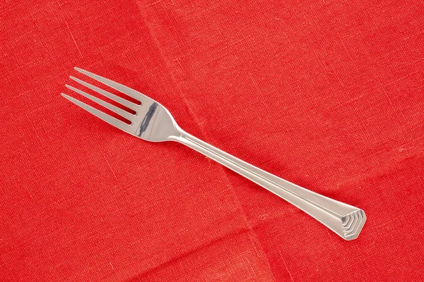 One Metal Fork Red Linen Napkin Macro Top View — Stock Photo, Image