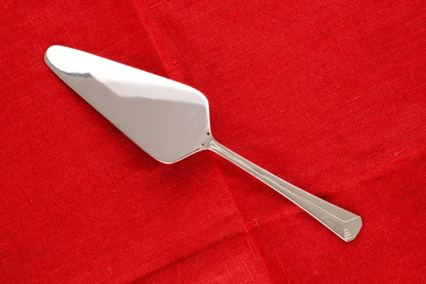 One Metal Spatula Dessert Red Linen Napkin Macro Top View — Stock Photo, Image