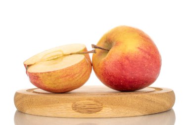 Tahta tepside bir buçuk ve bir bütün sulu organik elma, yakın çekim, beyaz arka plan izole.