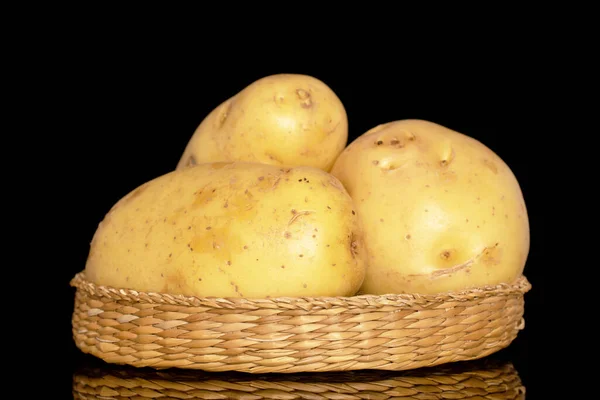 Three Raw Organic Potatoes Straw Plate Close Isolated Black Background — Stockfoto