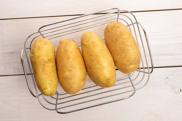 Several Fresh Peeled Organic Juicy Potatoes Basket Metal Wire Table — Stock Photo, Image