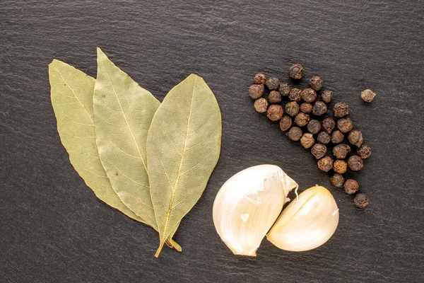 Dry Fragrant Black Pepper Bay Leaf Garlic Slate Stone Close — Stockfoto