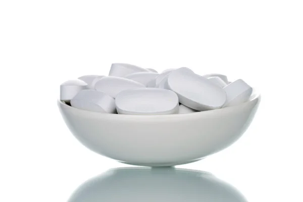 Several Vitamin Tablets White Ceramic Saucer Close Isolated White — Zdjęcie stockowe