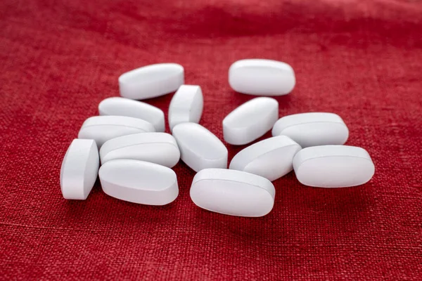 Several Vitamin Tablets Red Linen Napkin Close —  Fotos de Stock