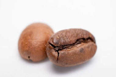 two coffee beans on a white background (macro)