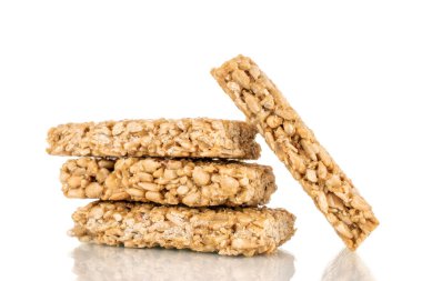 Four sweet roasted sweets from sunflower seeds and honey, macro, isolated on a white background.
