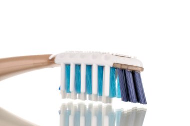 One plastic toothbrush, close-up, isolated on a white background.