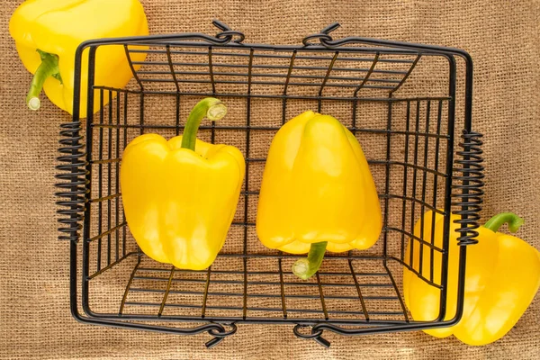 Four Ripe Yellow Sweet Peppers Basket Jute Fabric Close Top — стоковое фото
