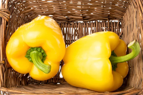 Two Sweet Peppers Bright Yellow Color Basket Macro — стоковое фото