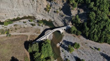 Aziz Aga 'nın eski taş köprüsü, Venetikos nehri, hava aracı manzarası, Grevena, Makedonya, Yunanistan