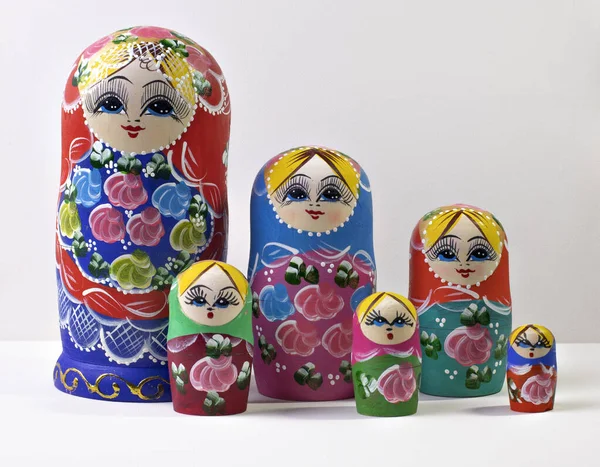 matryoshka and nesting dolls on white background